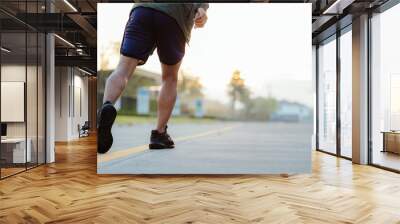 Portrait of a young Asian man in sports clothes jogging in the morning. man running at sunrise health care Wall mural