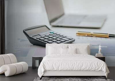 Selective focus office calculator with laptop and accessories on white background financial concept Wall mural