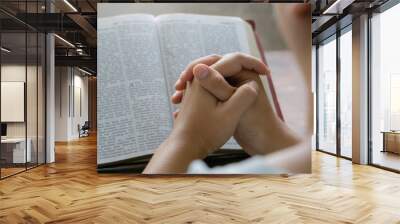 Bible concept.Man reading bible and praying to god before work. believe in goodness.Prayer on a wooden table.Concept for faith.copy space. Wall mural