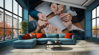 Christian group holding hands pray and worship god together on the sunday morning.spirituality, religion,believe.Christian life.Studying the word of God in church. Wall mural