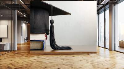 Graduation cap.Mortar board with degree paper and books on wood table. graduation concept. Wall mural