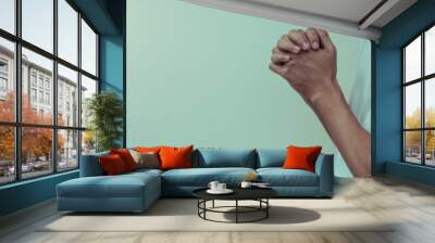 Hands folded in prayer at home.concept for faith, spirituality and religion, man praying in the morning. Wall mural