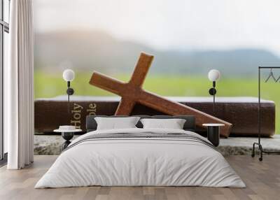 The cross and bible on stone with nature background.christian background Wall mural