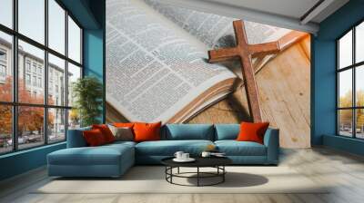 the cross over opened bible on wood table with window light. Wall mural