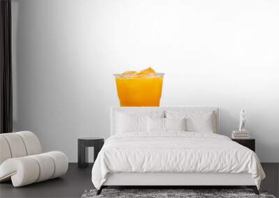 Orange juice in a plastic cup put ice on white background with clipping path. Wall mural