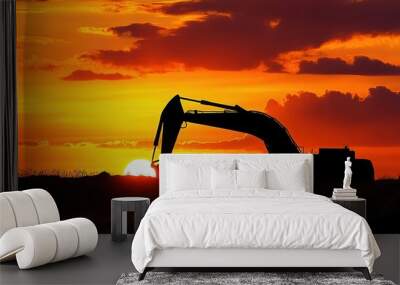 A large construction machine is silhouetted against a beautiful sunset Wall mural