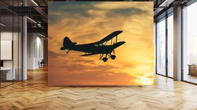 Vintage airplane flying in the sunset sky Wall mural