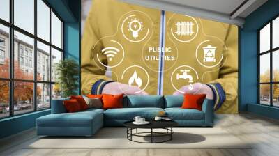 Man holding phone, using virtual interface sees text: PUBLIC UTILITIES. Smart public utilities concept. Water supply, electricity, gas, heating, sanitation, plumbing, household waste, internet access. Wall mural