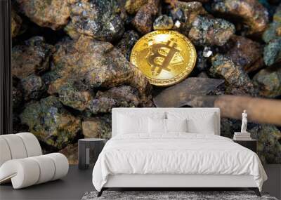 Top view close-up of a bitcoin stack of gold coins on a background of stones with a shovel. Cryptocurrency mining concept Wall mural