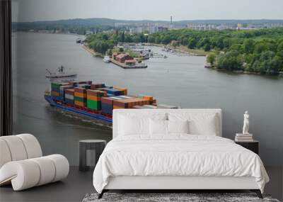 CONTAINER SHIP - Merchant vessel sails through the port channel on a sea voyage Wall mural