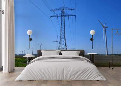 A row of wind turbines combined with high voltage power pylons Wall mural