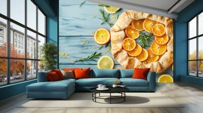 Delicious galette with citrus fruits and rosemary on blue wooden table, flat lay Wall mural