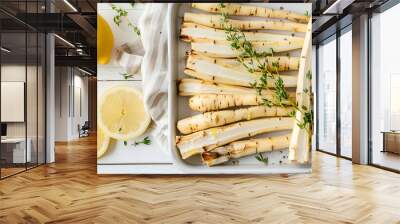 Dish with raw salsify roots, lemon and thyme on white wooden table, closeup. Space for text Wall mural