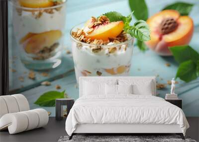 Tasty peach dessert with yogurt and granola on light blue wooden table Wall mural