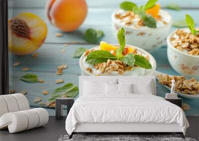 Tasty peach dessert with yogurt and granola on light blue wooden table Wall mural