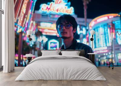 A confident young adult Japanese man poses outside a luxurious casino on the Vegas Strip, with neon lights creating a vibrant glow. The bustling nightlife and modern architecture form a stunning Wall mural