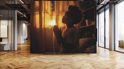 African American boy prays to god in dark children room. Cinematic effect Wall mural