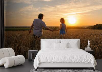 An adult farmer and his wife are walking hand in hand through their wheat field. Wall mural