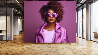 Fashion young african girl black woman wear stylish pink glasses clothes looking at camera isolated on party purple studio background Wall mural