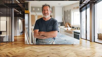 Mature man standing in his home kitchen, ready for DIY renovation work Wall mural