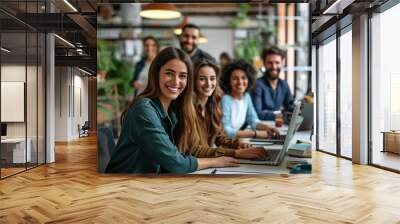 Successful business team smiling and sitting together in a startup office Wall mural