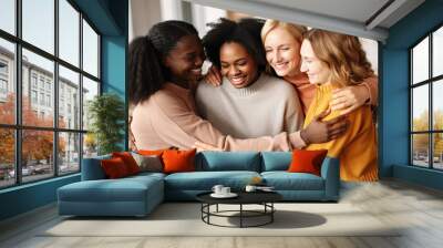 Supportive diverse female friends hugging each other at group therapy session Wall mural