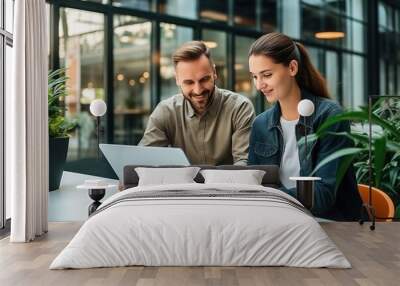 Two Young Creative Colleagues Discussing Work Project and pointing at the computer screen. Caucasian Male Supervisor Uses a Tablet and Consults Female Team Leader. Generative AI Wall mural