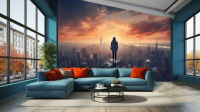 Businesswoman stands thoughtfully on a mountain overlooking a city with dramatic clouds in the sky Wall mural