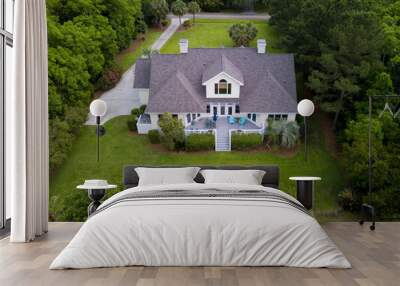 aerial view of large home with new roof on wooded grassy property Wall mural