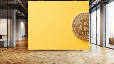 A gold colored coin with the letter B on it sits on a yellow background Wall mural