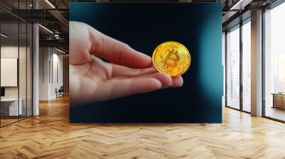 A hand holds a shiny gold Bitcoin, symbolizing digital currency and modern financial transactions in a contemporary setting. Wall mural