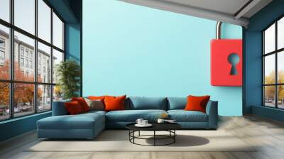 A hand points toward a red padlock against a light blue background, symbolizing security and protection. Wall mural