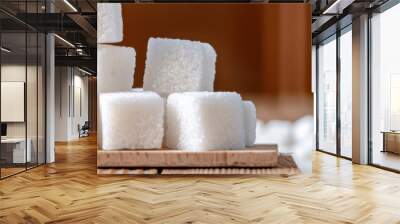 A pile of sugar cubes on a wooden surface Wall mural