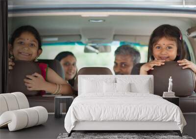 Indian family sitting in car Wall mural