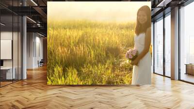 asian bride at outdoor in a morning surrounding by golden sunlig Wall mural