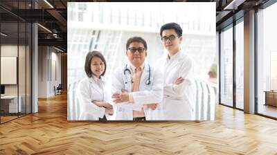 Asian medical team standing inside hospital building Wall mural