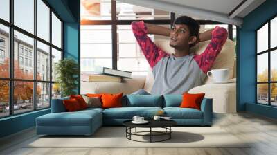 indian teenage male relaxing at home Wall mural