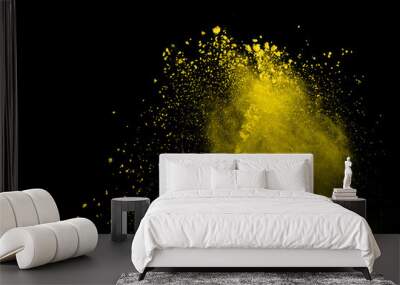 Abstract of yellow powder explosion on black background. Yellow powder splatted isolate. Colored cloud. Colored dust explode. Paint Holi. Wall mural