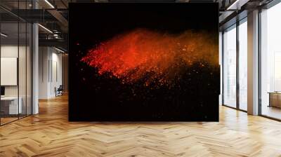 Explosion of colored powder isolated on black background. Power or clouds splatted. Freez motion of orange dust exploding. Wall mural