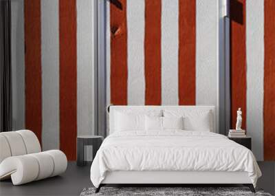 Weathered wall of street trade trailer with door and flaked off red stripes Wall mural