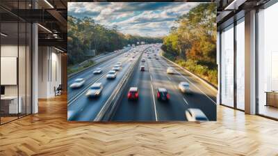 busy highway scene with multiple cars in motion, surrounded by lush greenery and cloudy sky, evokes sense of dynamic travel and urban life Wall mural