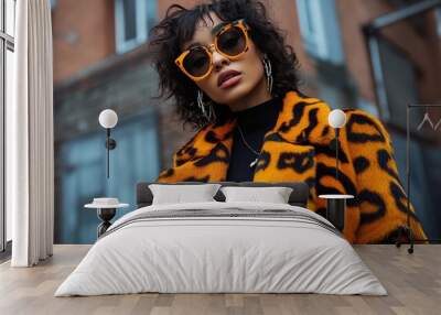 A woman wearing a bold animal print coat over a monochrome outfit, illustrating the use of statement pieces to elevate simple street style looks Wall mural