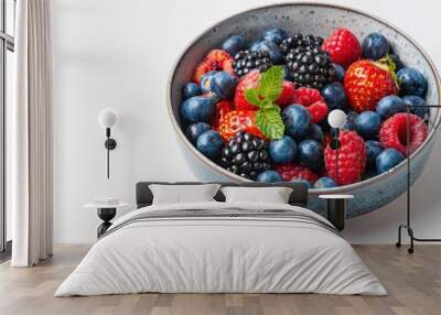 2. Assorted colorful berries in a bowl on a white background Wall mural