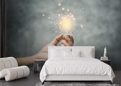 holding a bright light bulb.nnovation and energy concept.new ideas Great inspiration and innovation. Wall mural