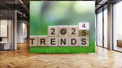 2025 trend concept, flip wooden cube, change year 2024 to 2025, green natural background. Wall mural