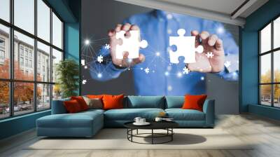 Businessman hands connecting puzzle pieces representing the merging of two companies or joint venture, partnership, Mergers and acquisition concept. Wall mural