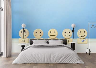 Customer service evaluation and satisfaction survey concepts. Happy face smile face icon on a wooden ball on table Wall mural