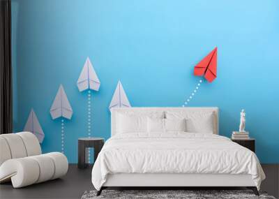 Group of white paper planes in one direction and one red paper plane pointing in different way on blue background. Business for new ideas creativity and innovative solution concepts. Wall mural