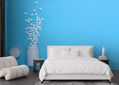 Heap of pills on blue background Wall mural