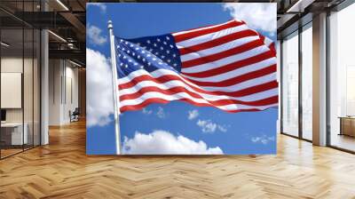 American flag waving against blue sky with clouds Wall mural